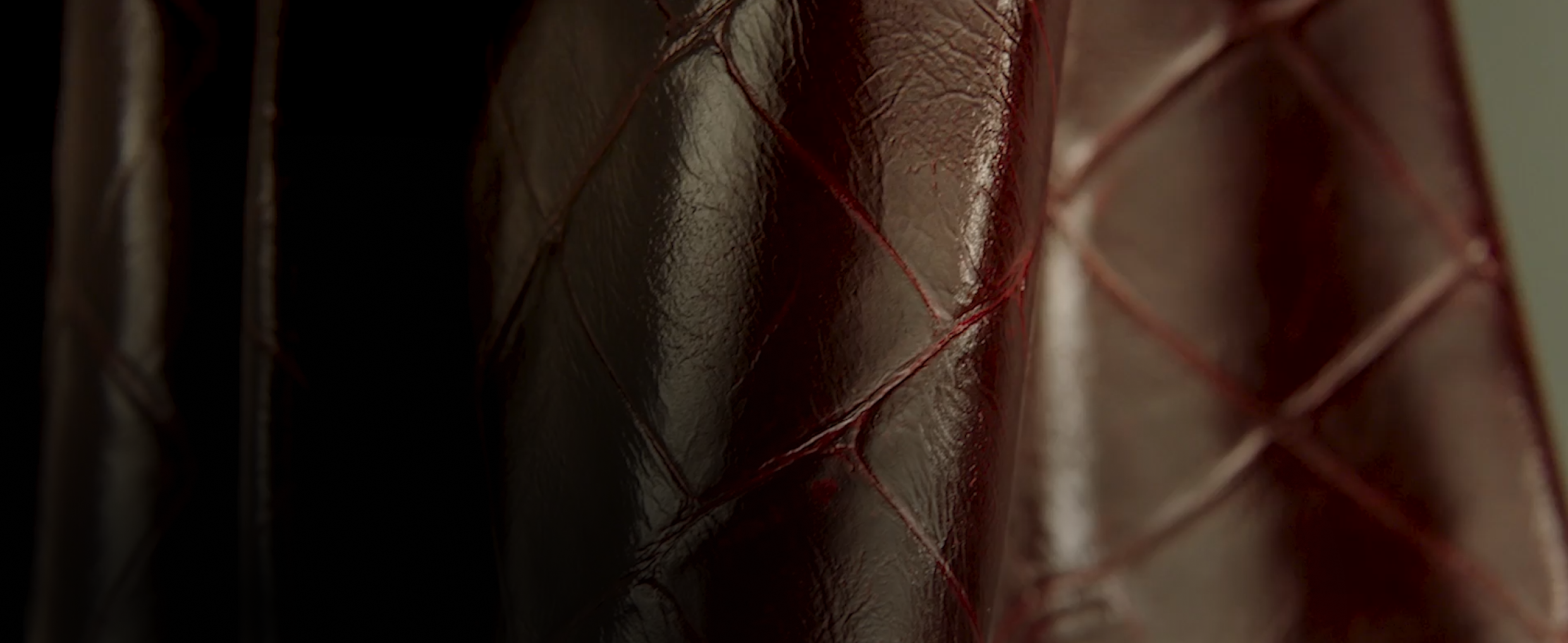 A close-up view of the texture of the burgundy Croc leather.