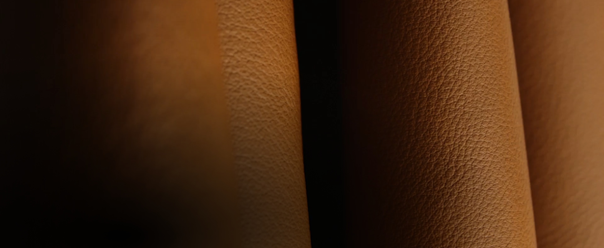 A close-up view of the texture of the amber-colored Cognac leather.