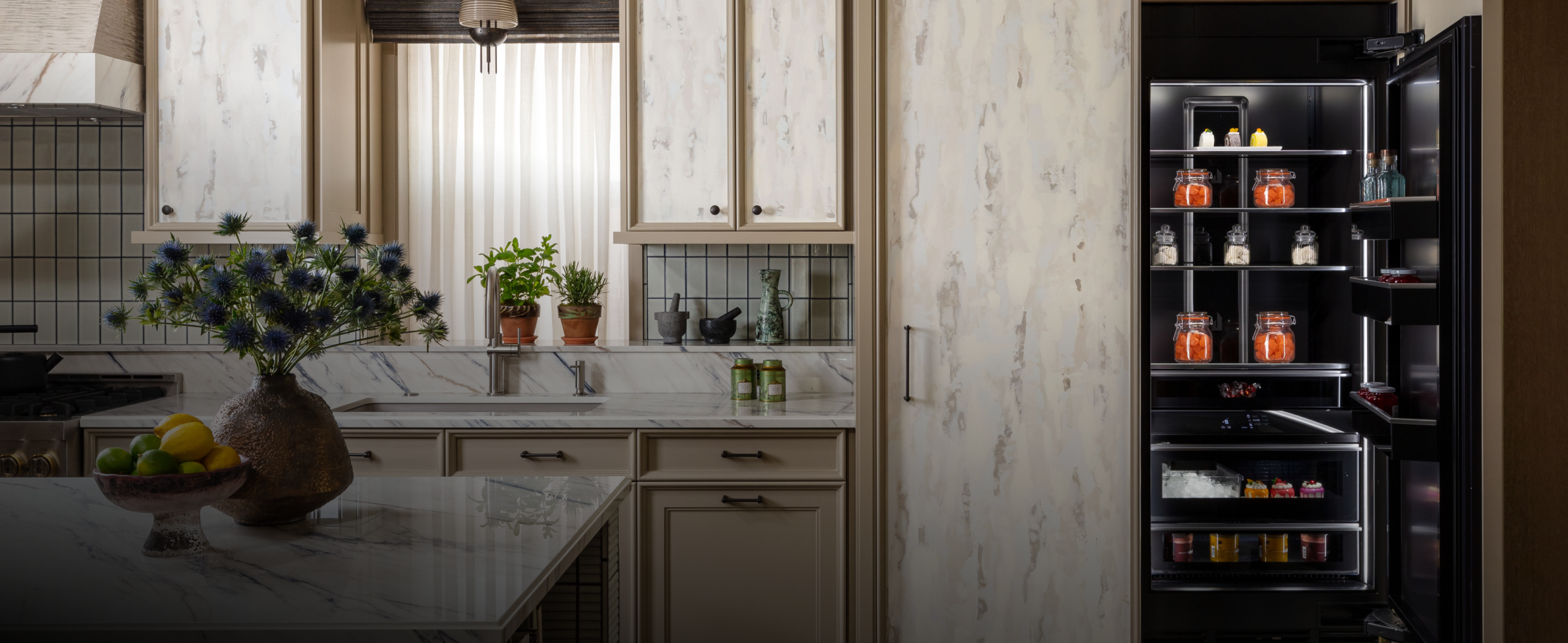 A luxury kitchen with a custom panel clad column. A luxury kitchen with a custom panel clad column.