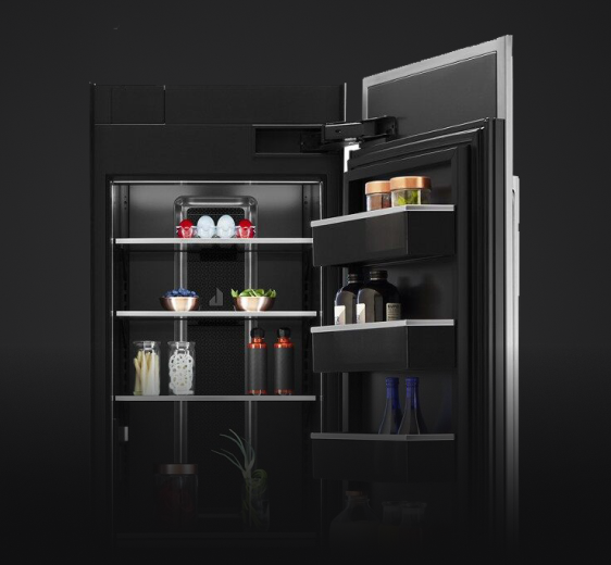 An open Column Refrigerator, propped with fine foods, luxury ingredients and high-end dishware.
