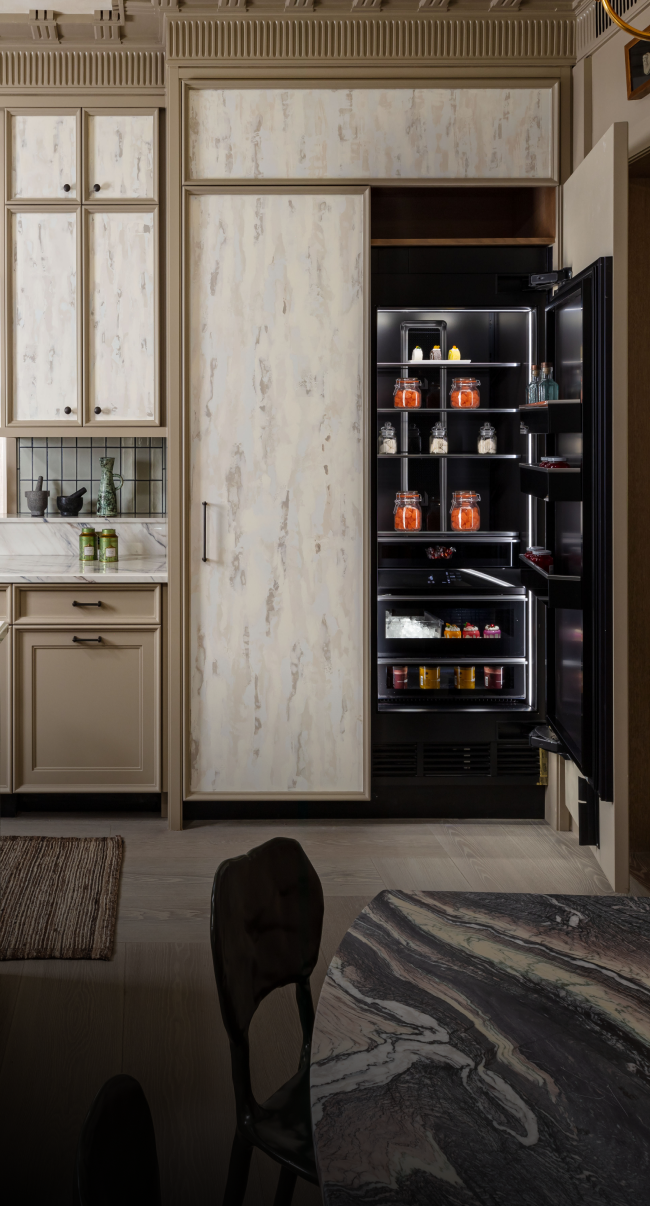A luxury kitchen with a custom panel clad column. A luxury kitchen with a custom panel clad column.