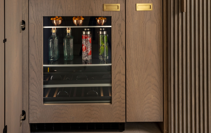 A close up of a JennAir® Beverage Center fitted with custom wooden panels. A close up of a JennAir® Beverage Center fitted with custom wooden panels.