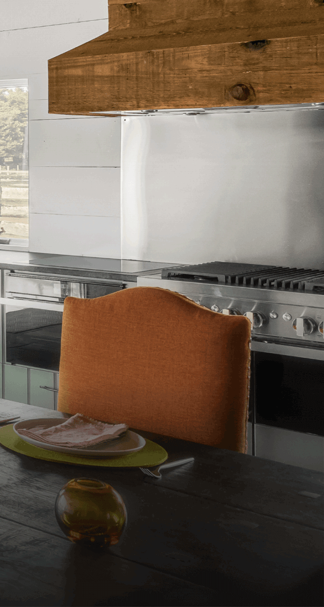 A NOIR™ Professional-Style Range in a blue kitchen. A NOIR™ Professional-Style Range in a blue kitchen.