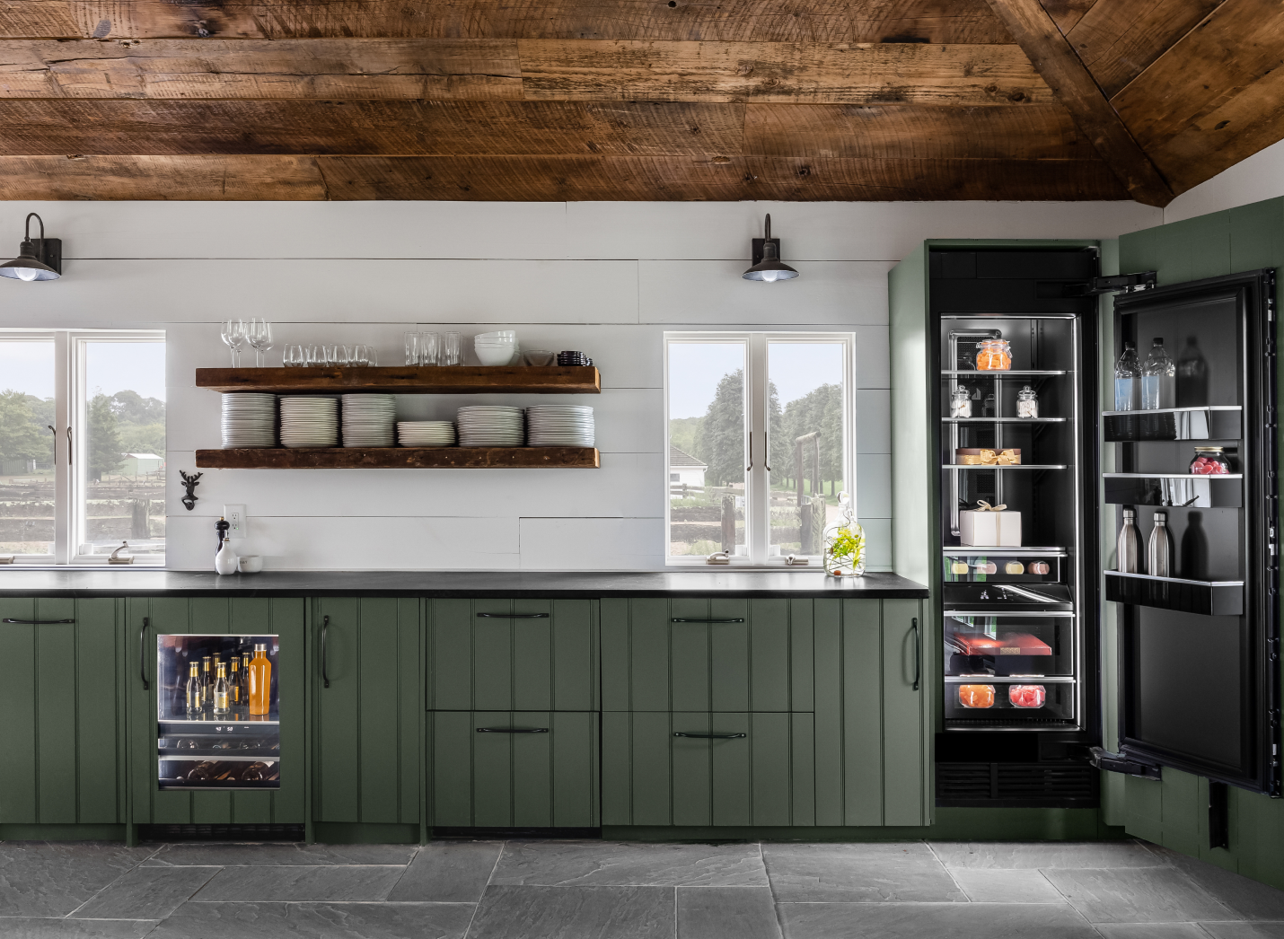 A view of the main bank of cabinets, featuring a panel-ready beverage center and a column refrigerator. A view of the main bank of cabinets, featuring a panel-ready beverage center and a column refrigerator.