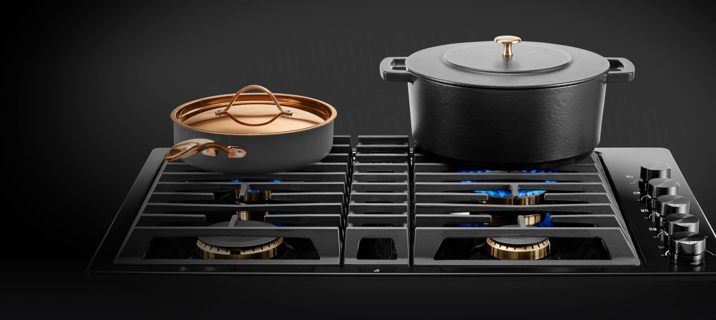 A frying pan and pot on a gas cooktop. A frying pan and pot on a gas cooktop.