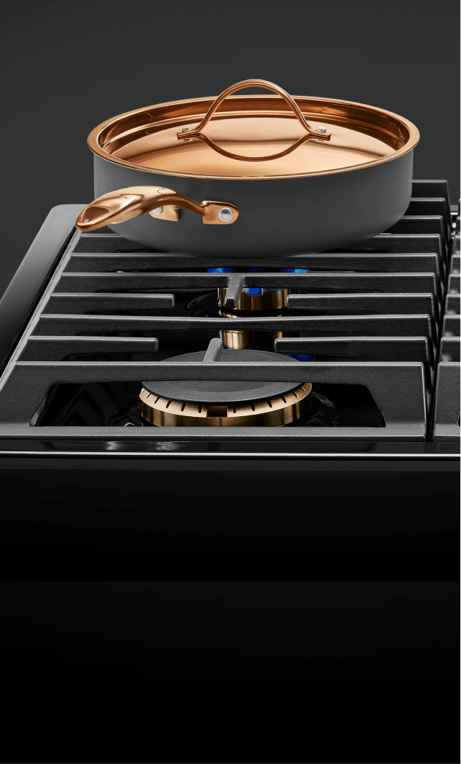 A frying pan and pot on a gas cooktop. A frying pan and pot on a gas cooktop.