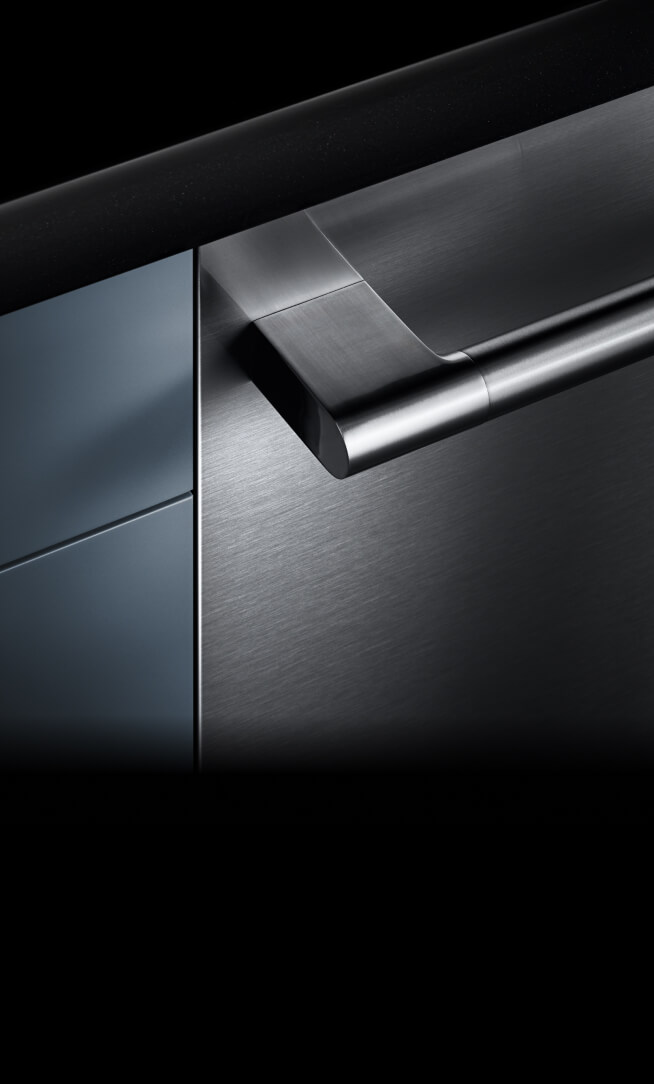 A dishwasher front and handle installed into a cabinet, showing off the fully flush design. A dishwasher front and handle installed into a cabinet, showing off the fully flush design.