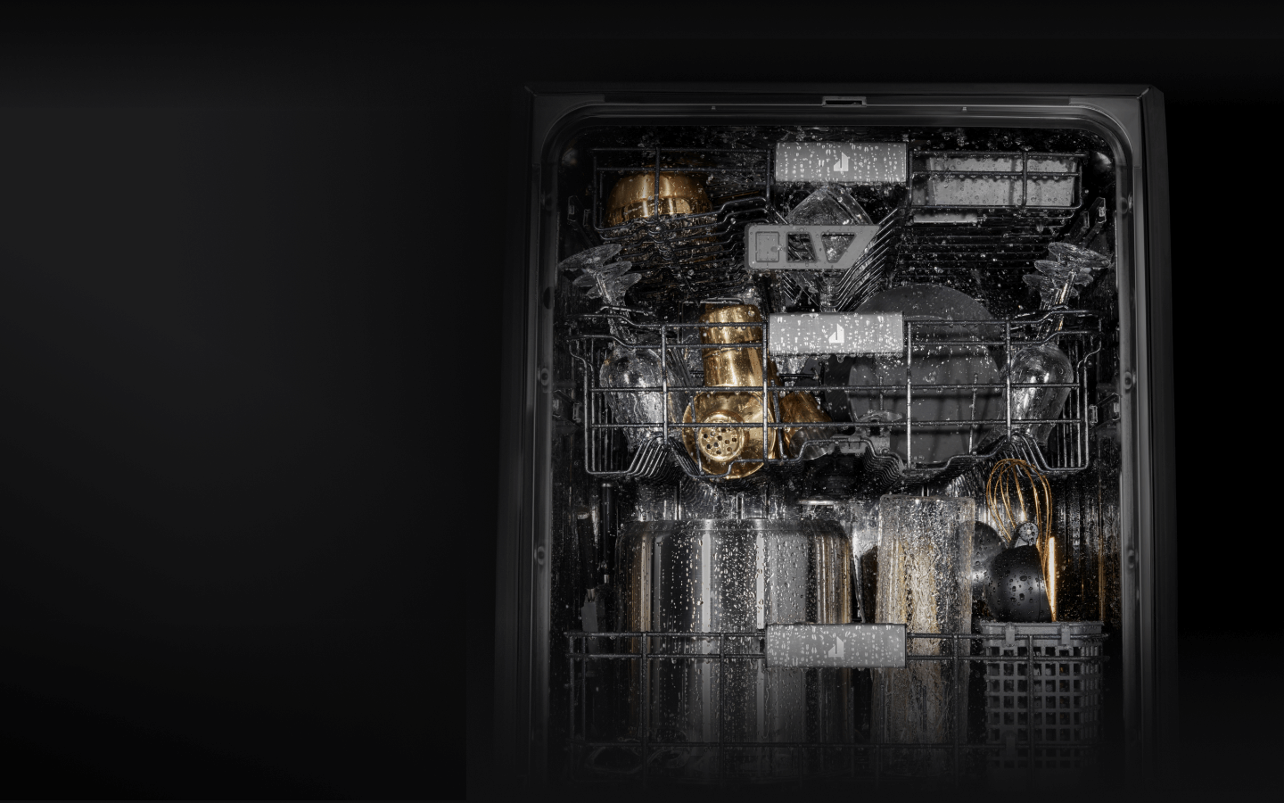 Water splashing around dishes in a JennAir® Dishwasher.