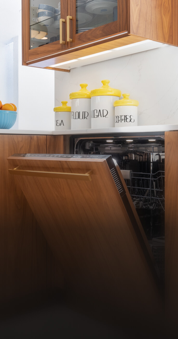 A JennAir® Panel-Ready Dishwasher in a kitchen with retro wooden cabinets. A JennAir® Panel-Ready Dishwasher in a kitchen with retro wooden cabinets.