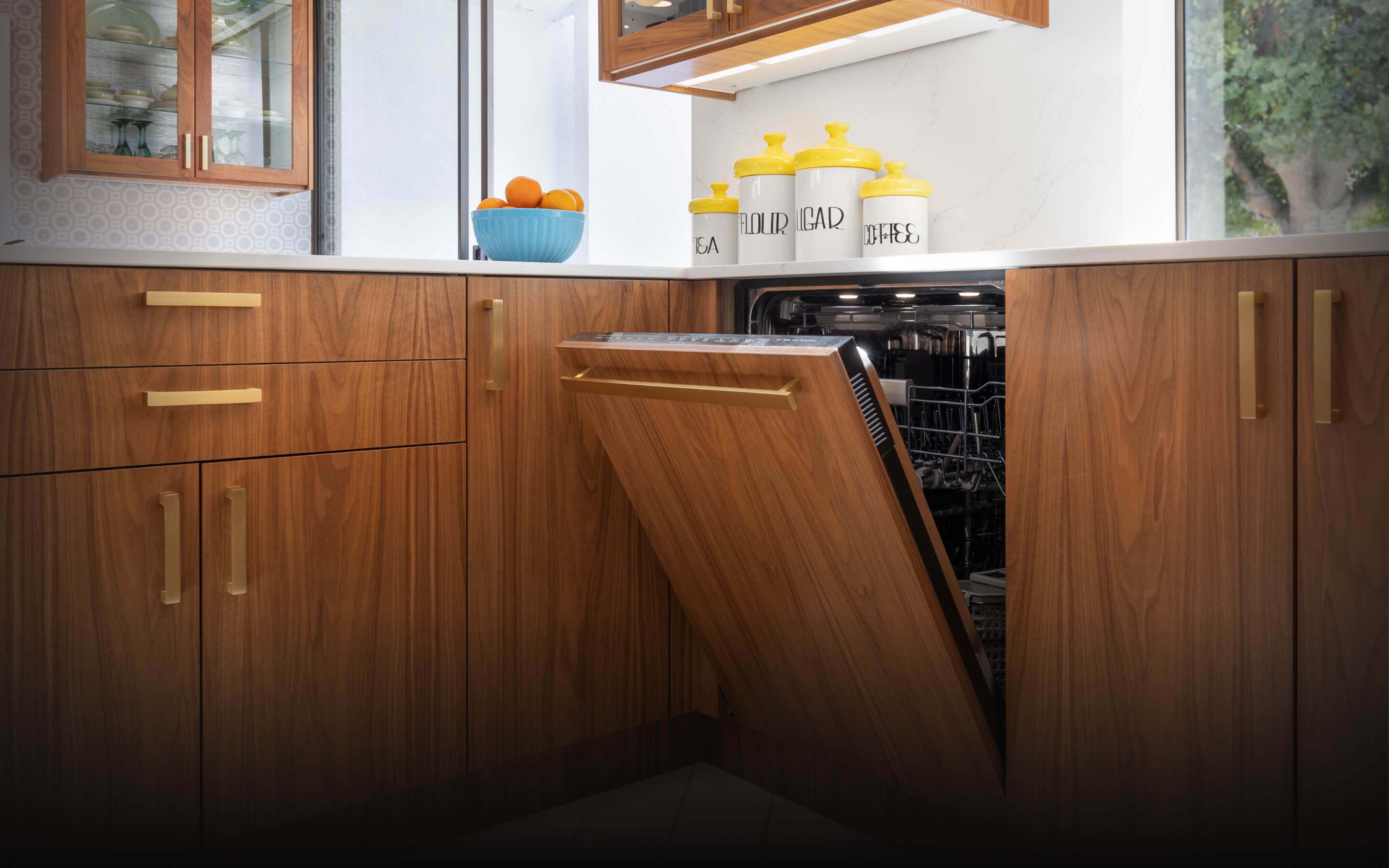A JennAir® Panel-Ready Dishwasher in a kitchen with retro wooden cabinets. A JennAir® Panel-Ready Dishwasher in a kitchen with retro wooden cabinets.