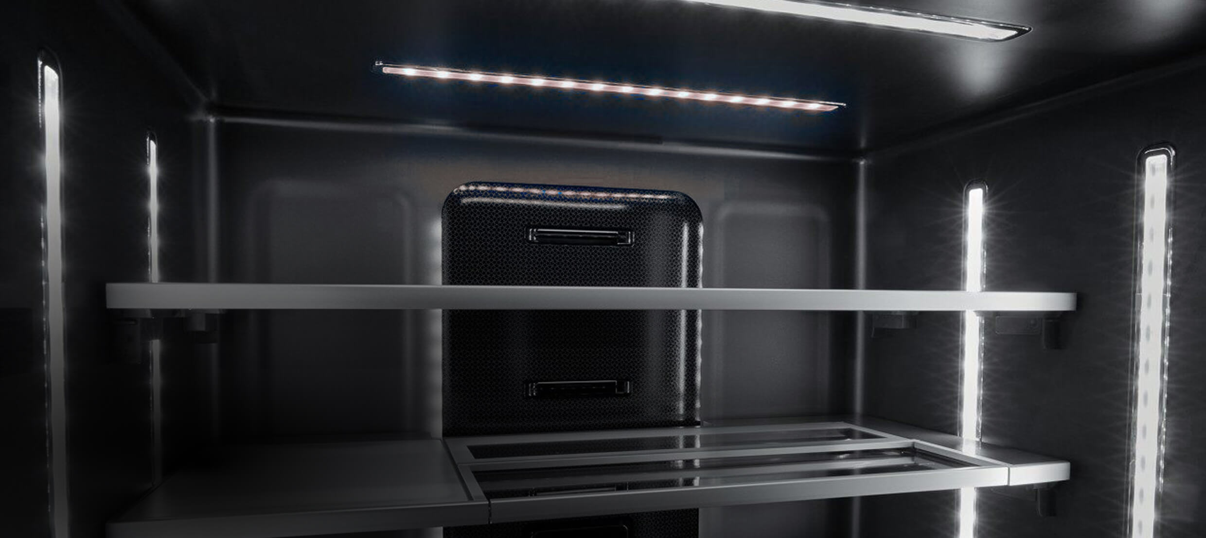 The illuminated Obsidian interior of a freestanding refrigerator. The illuminated Obsidian interior of a freestanding refrigerator.
