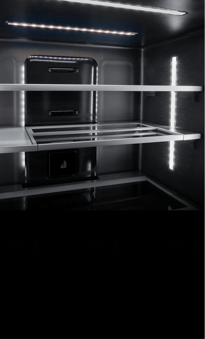 The illuminated Obsidian interior of a freestanding refrigerator. The illuminated Obsidian interior of a freestanding refrigerator.