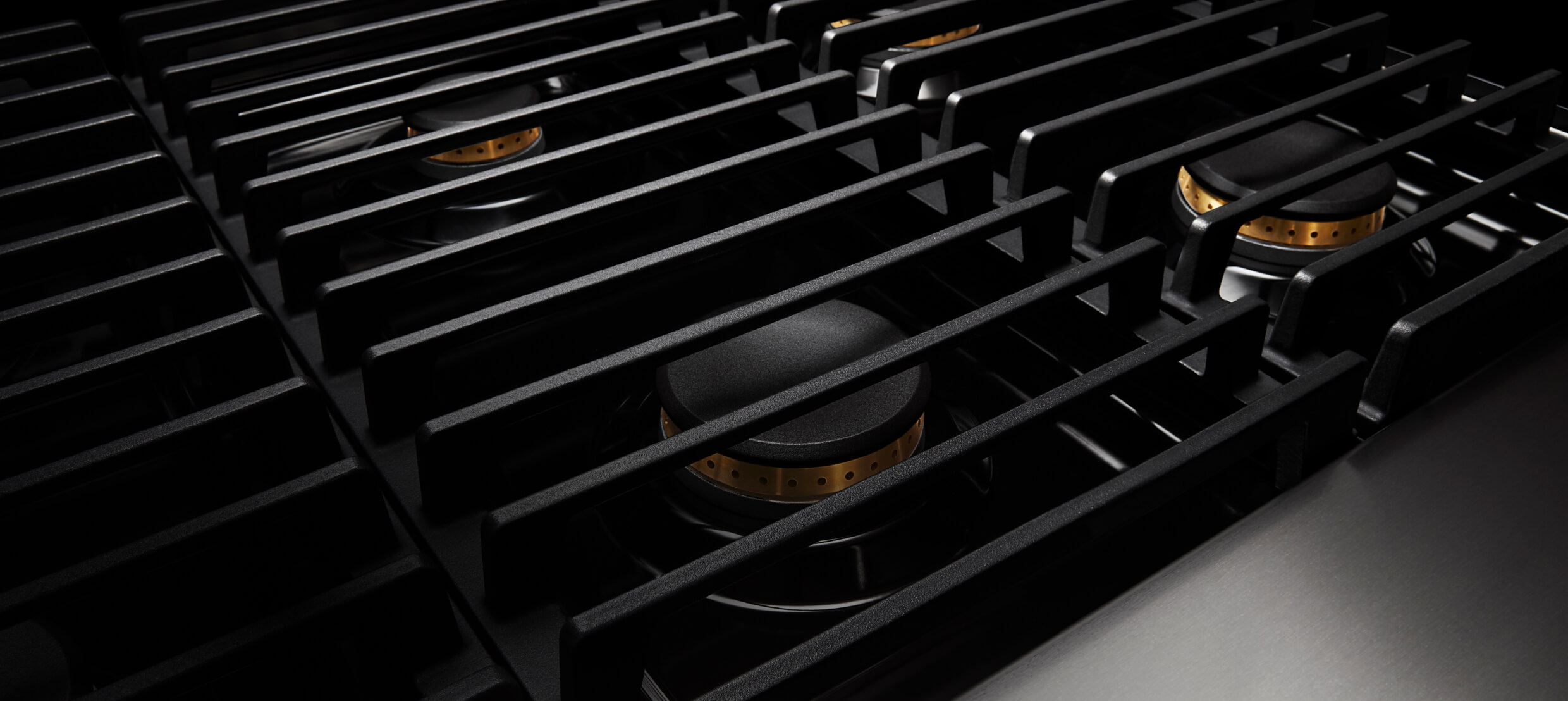 Closeup of the cast iron grates on a gas rangetop. Closeup of the cast iron grates on a gas rangetop.