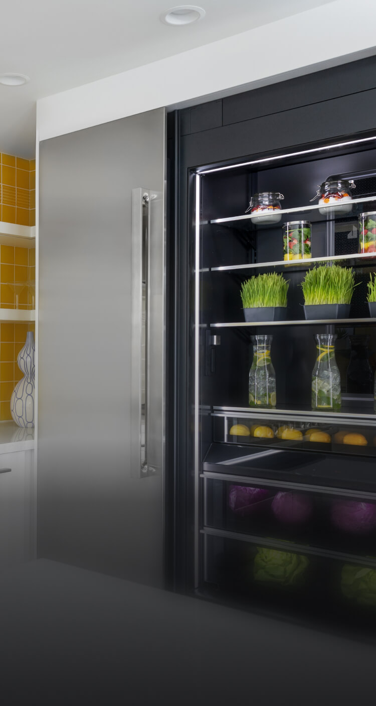 A bold yellow kitchen featuring NOIR™ appliances.