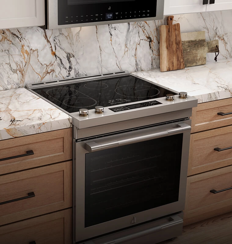 An induction slide-in range in a white and wood kitchen.