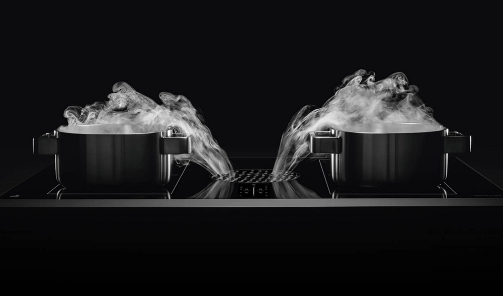 Two pans with the steam being pulled into the center vent.