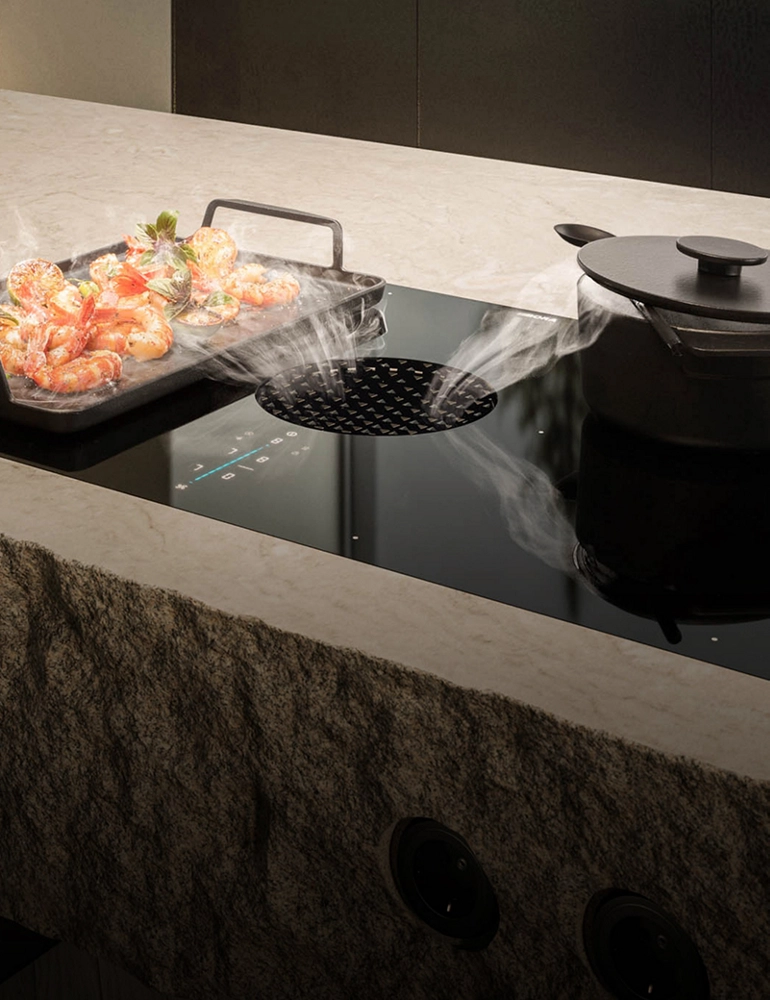 A griddle and pan on an induction downdraft cooktop.