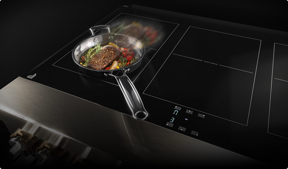 A pan sliding across an induction cooking surface.
