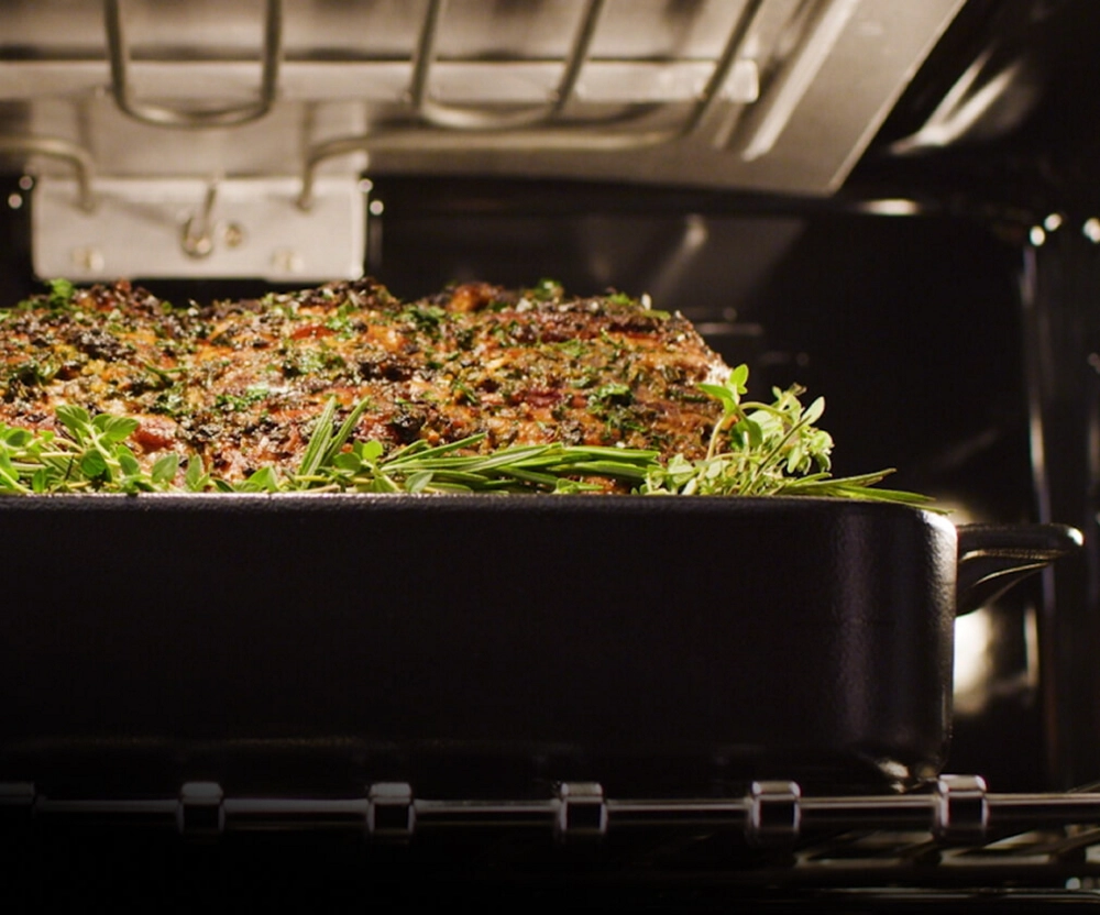 A roast cooking in an oven.