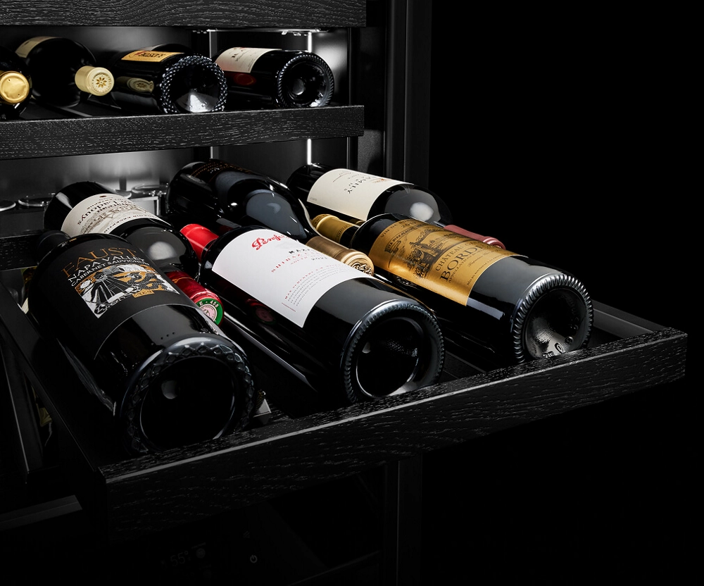 Three wine bottles on a pulled-out rack.