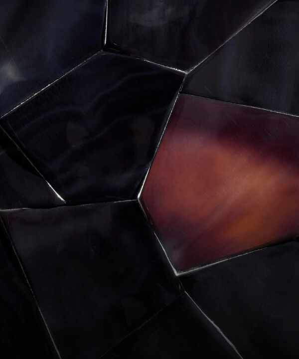 A burgundy tortoiseshell pattern made out of dark Pen shell, called Dark Pen Carnelian.