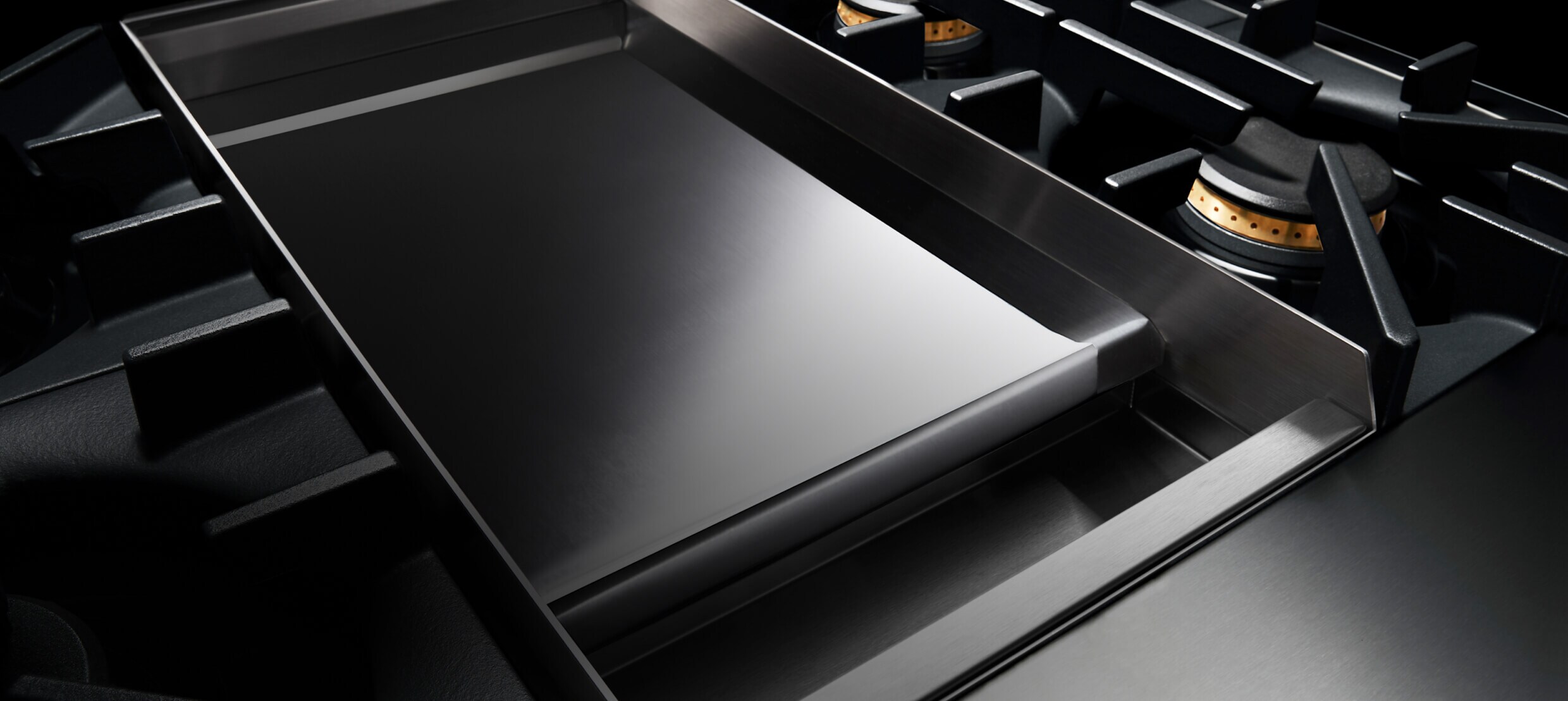 The mirror-like Chrome-Infused Griddle on a JennAir® RISE™ Professional-Style Range.