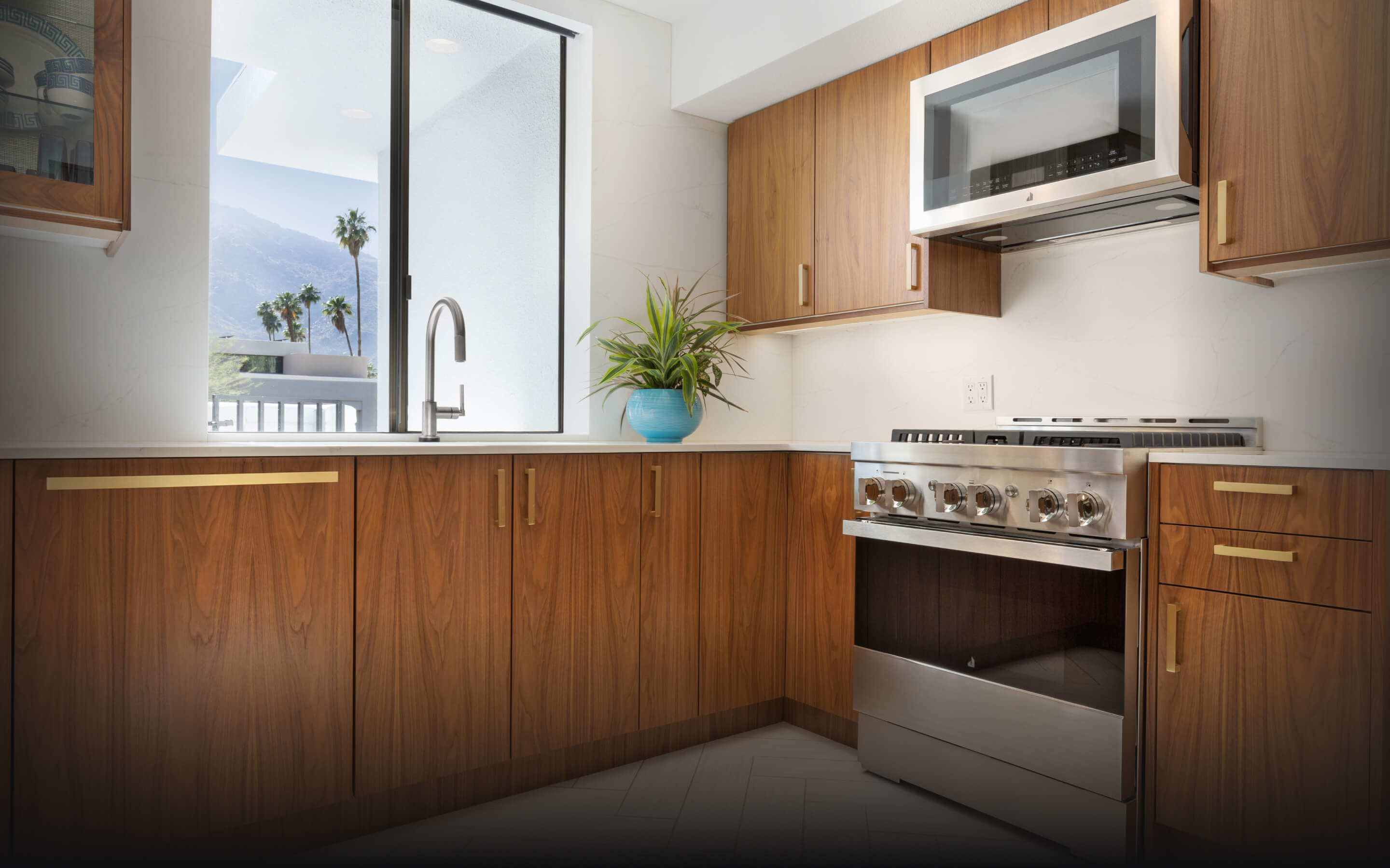 A JennAir® NOIR™ Gas Range in a mid-century modern luxury kitchen.