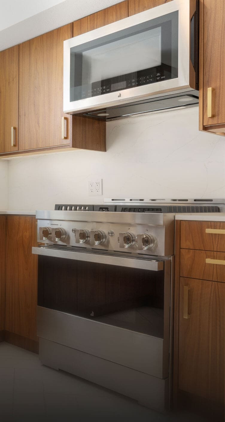 A JennAir® NOIR™ Gas Range in a mid-century modern luxury kitchen.