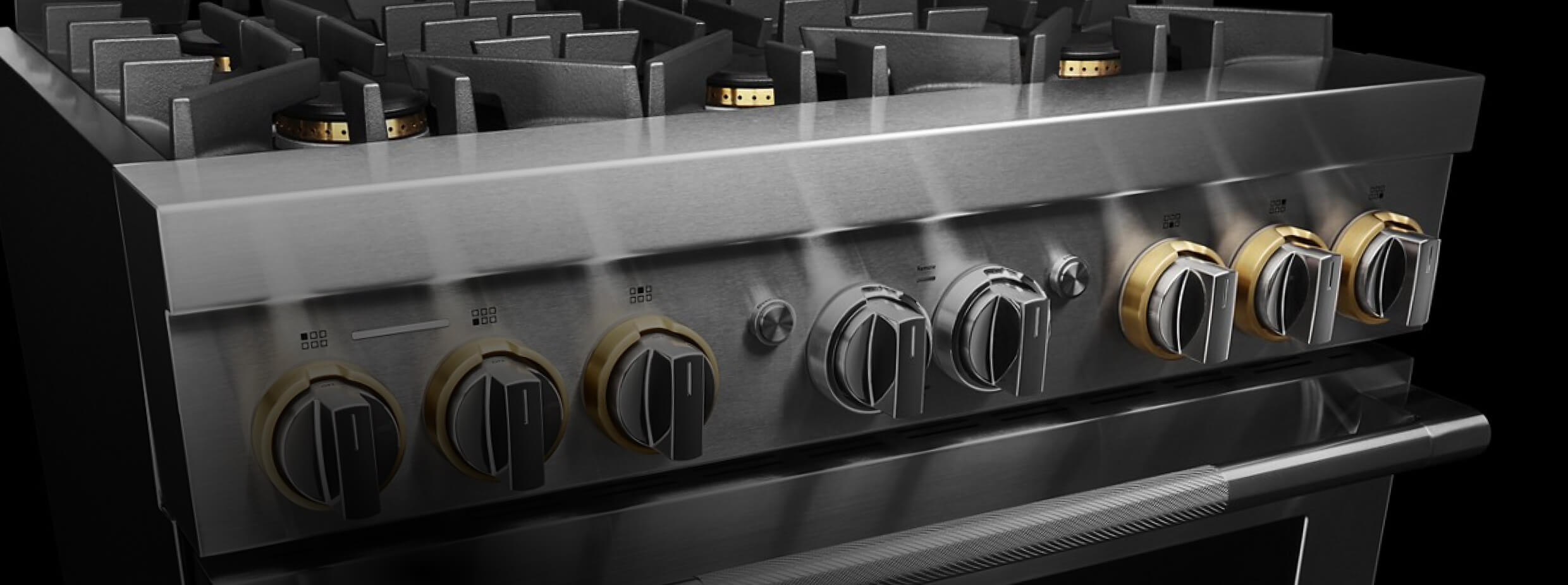 The top half of a JennAir® RISE™ Design Expression Professional-Style Range, showing the brass details on the knobs and burners.
