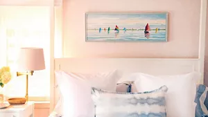 The bed and side table decor in the Pink Bedroom. 