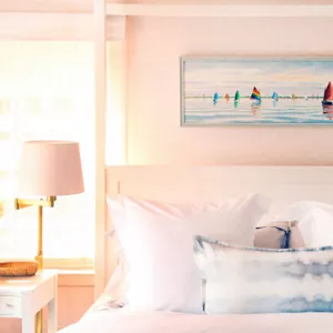 The bed and side table decor in the Pink Bedroom. 