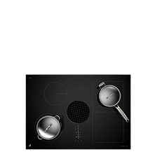 A downdraft induction cooktop with stainless steel pans on top.